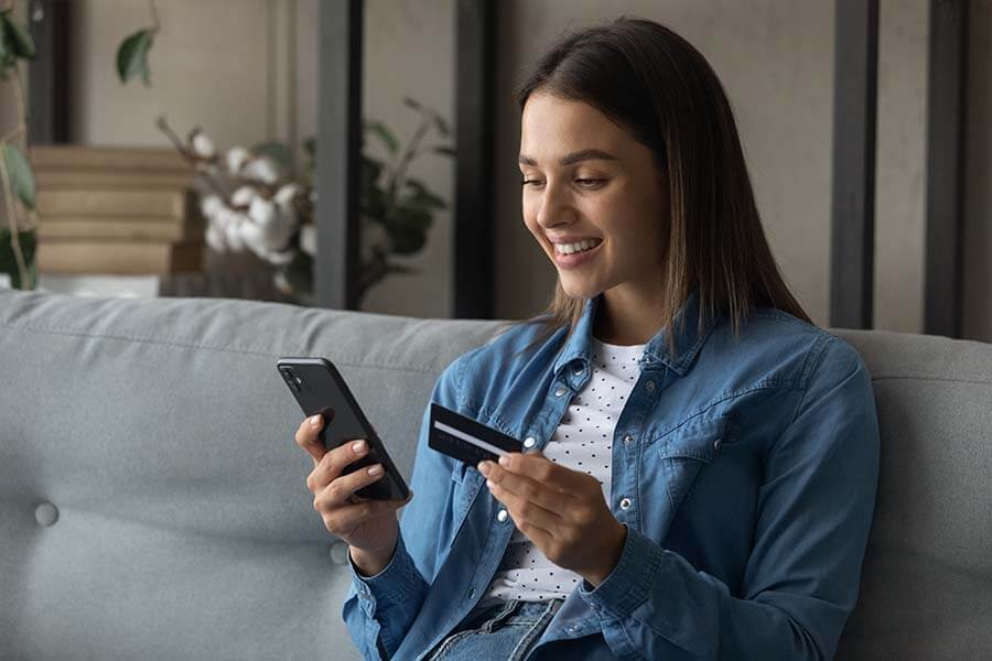 Young woman using her first credit card to build a good credit score.